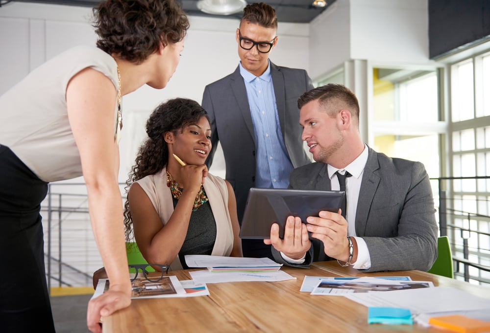 team of successful business people having a meeting in executive sunlit office