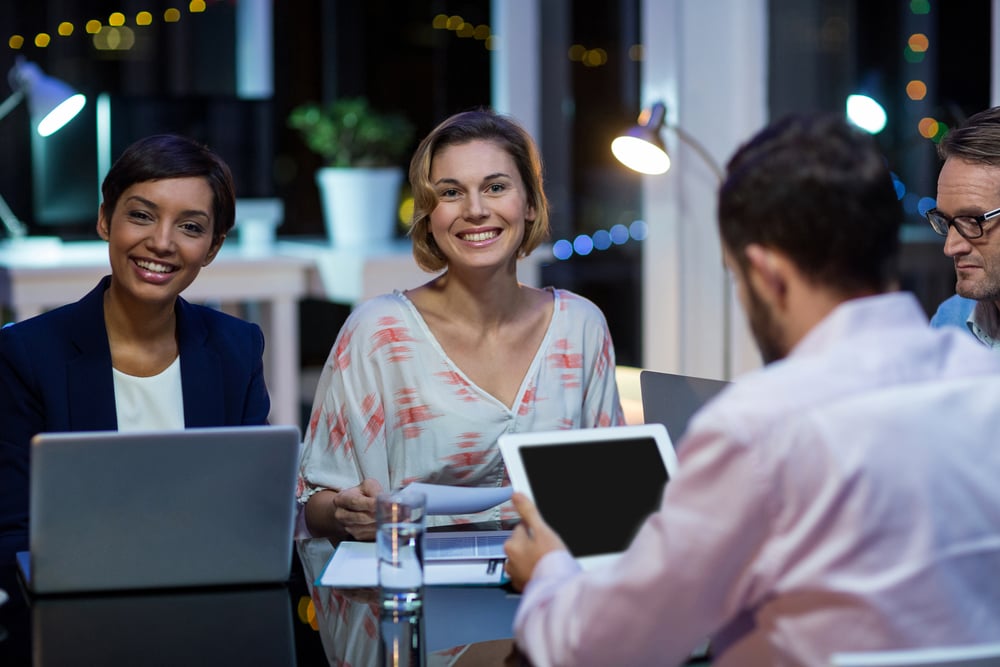 Coworkers discussing practical solutions for their NetSuite problems.