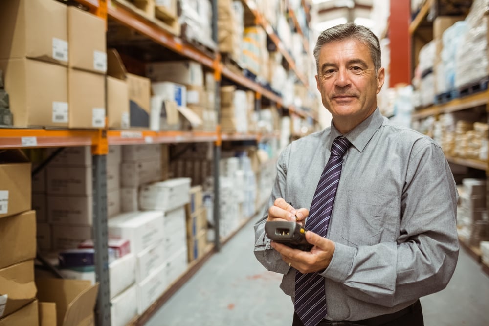 Businessman using ERP software to manage his distribution company.