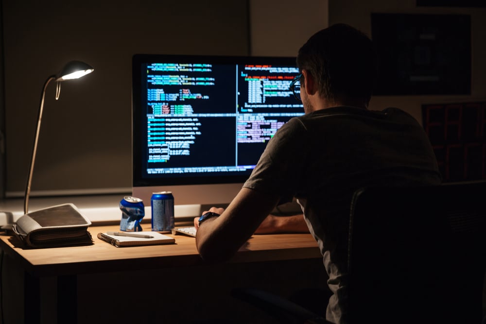 A programmer customizing an ERP in a dark room