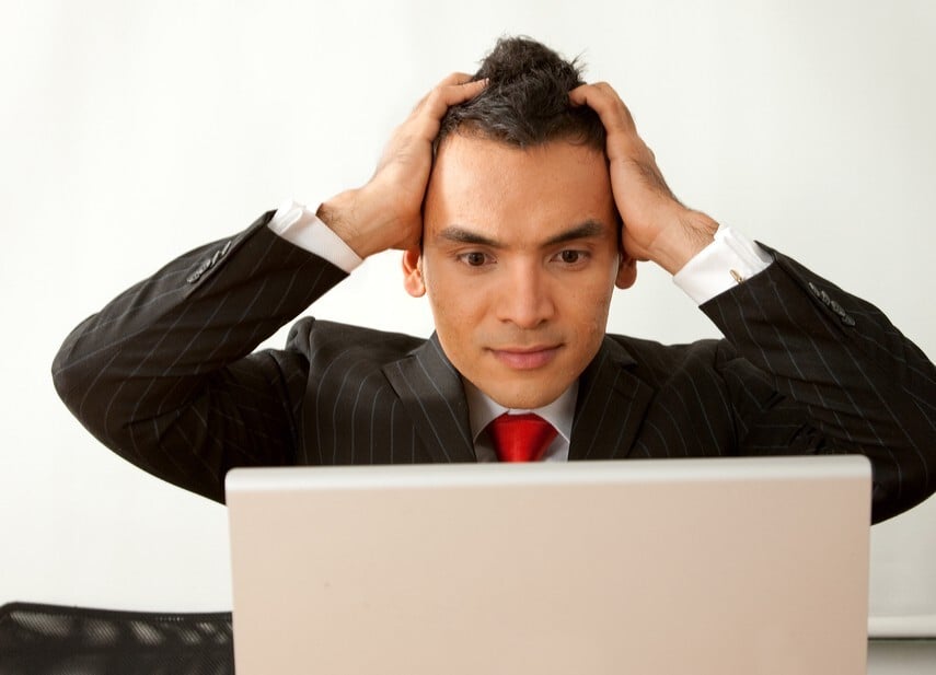 Business man with a laptop upset that his ERP platform is glitching