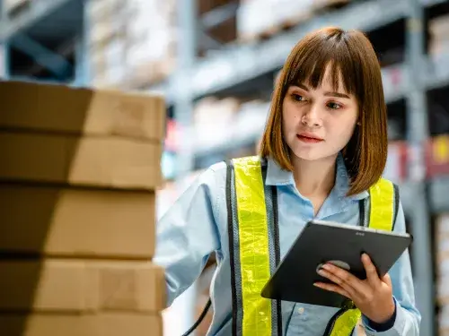 woman checks shipping and inventory with mobile ERP system